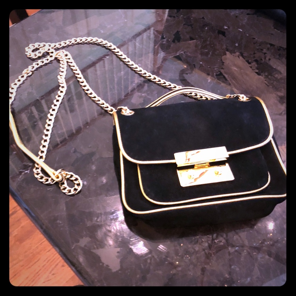 Michael Kors suede black bag with gold hardware.